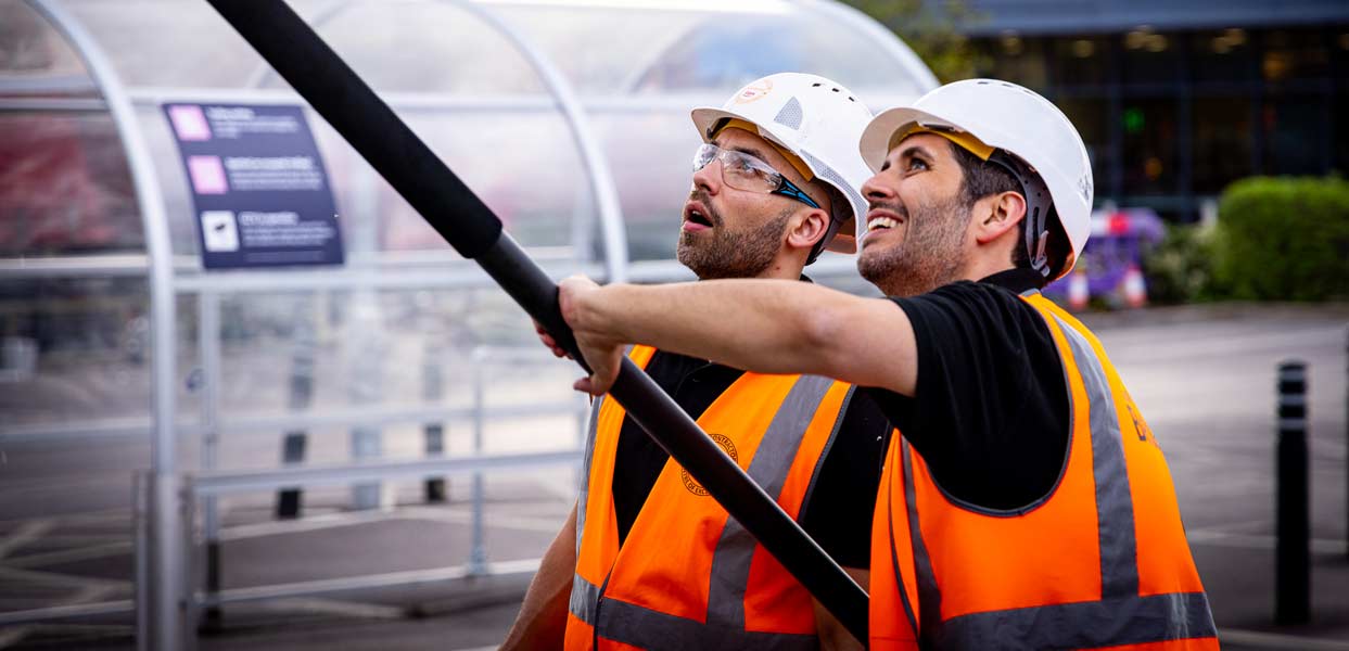 Team Safely Cleaning Building Exterior